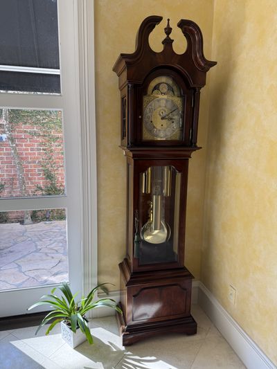 A mahogany longcase clock with a brass dial