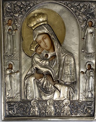 An icon of the Madonna and Child in a chased silver and gilt oklad, with saints worked into the border