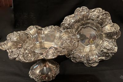 A pair of sterling silver repousse compotes with a smaller footed dish